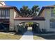 Walkway leads to a courtyard with tropical landscaping and building access at 1111 Faith W Cir # 2003, Bradenton, FL 34212