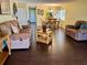 Open concept living room and dining area with dark hardwood floors at 1111 Faith W Cir # 2003, Bradenton, FL 34212