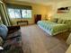 Main bedroom with king bed, view, and additional seating area at 1111 Faith W Cir # 2003, Bradenton, FL 34212
