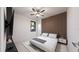 Spacious bedroom with a king-size bed, ceiling fan and accent wall at 12198 Terkelsen Ave, Port Charlotte, FL 33981
