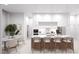 Modern kitchen with white cabinets and island seating at 12198 Terkelsen Ave, Port Charlotte, FL 33981