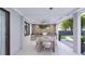 Covered patio with outdoor kitchen, dining area, and lounge chairs at 12198 Terkelsen Ave, Port Charlotte, FL 33981