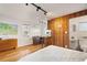 Cozy bedroom with wood floors and access to kitchenette and bathroom at 14900 Coker Gully Rd, Myakka City, FL 34251