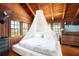 Charming bedroom with wood ceiling, canopy bed, and large windows at 14900 Coker Gully Rd, Myakka City, FL 34251