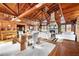 Open concept dining area with rustic wood table and exposed beams at 14900 Coker Gully Rd, Myakka City, FL 34251