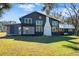 Renovated farmhouse showcasing a unique architectural style and landscaping at 14900 Coker Gully Rd, Myakka City, FL 34251