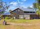 Dark-colored home with screened porch and star detail at 14900 Coker Gully Rd, Myakka City, FL 34251