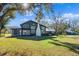 Dark-colored home with brick chimney and large yard at 14900 Coker Gully Rd, Myakka City, FL 34251