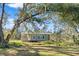 Gray modern farmhouse exterior with large windows at 14900 Coker Gully Rd, Myakka City, FL 34251