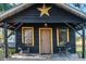 Rustic cabin exterior with yellow trim and star detail at 14900 Coker Gully Rd, Myakka City, FL 34251