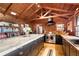 Modern kitchen with dark cabinetry, a large island, and wood beams at 14900 Coker Gully Rd, Myakka City, FL 34251