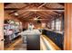 Modern kitchen with dark cabinetry, large island, wood beams, and wood floors at 14900 Coker Gully Rd, Myakka City, FL 34251