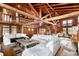 Spacious living area with high ceilings, exposed beams, and comfortable seating at 14900 Coker Gully Rd, Myakka City, FL 34251