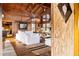 Living room with high ceilings, exposed beams, and a view into the kitchen at 14900 Coker Gully Rd, Myakka City, FL 34251