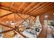 Loft view overlooking the living room with exposed beams and high ceilings at 14900 Coker Gully Rd, Myakka City, FL 34251