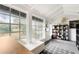 Bright sunroom with ample natural light, tiled floor, and storage shelves at 14900 Coker Gully Rd, Myakka City, FL 34251
