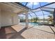 Inviting pool and spa with screened enclosure and brick pavers at 15145 Spanish Point Dr, Port Charlotte, FL 33981