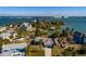 Aerial view of a home situated on a quiet street with water access nearby at 15815 Redington Dr, Redington Beach, FL 33708