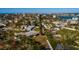 Aerial view of a home near the water with lush landscaping and dock at 15815 Redington Dr, Redington Beach, FL 33708