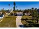 Aerial view of a single-story home with a private dock and lush landscaping at 15815 Redington Dr, Redington Beach, FL 33708