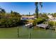 Aerial view of waterfront home with private dock and lush landscaping at 15815 Redington Dr, Redington Beach, FL 33708