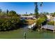 Aerial view of waterfront home with private dock and lush landscaping at 15815 Redington Dr, Redington Beach, FL 33708