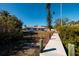 Backyard of the home with access to a private dock, channel waterway, and beautiful tropical greenery at 15815 Redington Dr, Redington Beach, FL 33708
