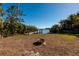 Private backyard with fire pit and waterfront access at 15815 Redington Dr, Redington Beach, FL 33708