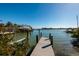 Long wooden private boat dock with deep water access and gorgeous water views on a sunny day at 15815 Redington Dr, Redington Beach, FL 33708