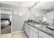 Double vanity bathroom with granite countertop and view of bedroom at 18184 Sullivan Ave, Port Charlotte, FL 33954