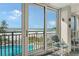 Balcony with chairs overlooking the beach and pool at 19 Whispering Sands Dr # 301, Sarasota, FL 34242