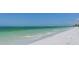 Stunning beachfront view featuring white sand and blue-green ocean waters on a sunny day at 19 Whispering Sands Dr # 301, Sarasota, FL 34242