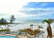 Breathtaking beach view with a turquoise ocean, sandy shore, and a pristine pool in the foreground at 19 Whispering Sands Dr # 301, Sarasota, FL 34242