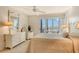 Bright bedroom with ocean view and white dresser at 19 Whispering Sands Dr # 301, Sarasota, FL 34242