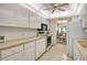 Well-equipped kitchen featuring white cabinetry and granite counters at 19 Whispering Sands Dr # 301, Sarasota, FL 34242