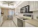 Kitchen with white cabinetry, modern appliances, and adjacent breakfast nook at 19 Whispering Sands Dr # 301, Sarasota, FL 34242