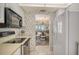 Bright kitchen with white cabinetry and appliances, opening to a dining area with ocean views at 19 Whispering Sands Dr # 301, Sarasota, FL 34242