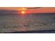 Captivating sunset over the ocean, casting a warm glow on the water's surface at 19 Whispering Sands Dr # 301, Sarasota, FL 34242