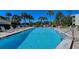 Inviting community pool with ample lounge chairs at 19 Whispering Sands Dr # 301, Sarasota, FL 34242