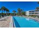 Relaxing community pool with lounge chairs and patio at 19 Whispering Sands Dr # 301, Sarasota, FL 34242
