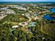Aerial view of community with tennis courts, playground, and lake at 20345 Reale Cir, Venice, FL 34293