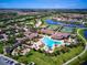 Aerial view of community with resort-style pool and tennis courts at 20345 Reale Cir, Venice, FL 34293