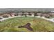 Aerial view of cul-de-sac with homes and a landscaped center at 20345 Reale Cir, Venice, FL 34293