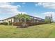Spacious backyard with screened enclosure and lush landscaping at 20345 Reale Cir, Venice, FL 34293