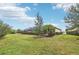Landscaped backyard showcasing a home's side elevation at 20345 Reale Cir, Venice, FL 34293