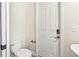 Simple toilet and wall-mounted fixtures in a small bathroom at 20345 Reale Cir, Venice, FL 34293