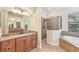 Bathroom with granite double vanity and walk in shower at 20345 Reale Cir, Venice, FL 34293