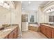 Bathroom with granite countertops, soaking tub, and walk-in shower at 20345 Reale Cir, Venice, FL 34293