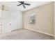Bedroom with ceiling fan, carpet, and double-door closet at 20345 Reale Cir, Venice, FL 34293
