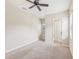 Bright bedroom featuring ceiling fan, carpet, and private bath access at 20345 Reale Cir, Venice, FL 34293